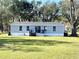 Exterior backyard view with well maintained lawn and home at 9619 Moore Rd, Lakeland, FL 33809