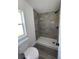 Clean bathroom with walk-in shower and wood-look flooring at 9619 Moore Rd, Lakeland, FL 33809