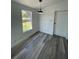 Spacious bedroom with wood-look flooring and large window at 9619 Moore Rd, Lakeland, FL 33809