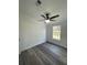 Bright bedroom featuring wood-look floors and ceiling fan at 9619 Moore Rd, Lakeland, FL 33809