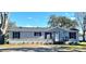 Gray mobile home with black shutters and landscaping at 9619 Moore Rd, Lakeland, FL 33809