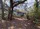 Side view of home featuring exterior paint, sunroom, mature trees, and landscaping at 1024 Driggers Rd, Lakeland, FL 33809