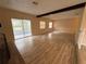 Open living area with wood flooring, sliding door and a brick fireplace at 1024 Driggers Rd, Lakeland, FL 33809