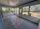 Bright sun room with multiple windows overlooking the backyard and unique floor pattern at 1024 Driggers Rd, Lakeland, FL 33809