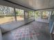 Bright sun room featuring multiple windows and painted diamond pattern on the floor at 1024 Driggers Rd, Lakeland, FL 33809