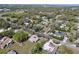 Expansive aerial view of a neighborhood showcasing lush landscaping and mature trees at 1025 E Georgia St, Bartow, FL 33830