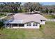 Birds eye view showing the home, backyard, and surrounding mature trees at 1025 E Georgia St, Bartow, FL 33830