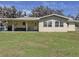 Exterior view of the back of the home, featuring the patio and large backyard at 1025 E Georgia St, Bartow, FL 33830