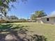 Large, well-maintained backyard with green grass and perimeter fence at 1025 E Georgia St, Bartow, FL 33830