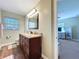 Bathroom featuring a vanity with granite countertops and a large mirror at 1025 E Georgia St, Bartow, FL 33830