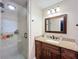 Updated bathroom featuring a glass shower and granite vanity with dark wood cabinets at 1025 E Georgia St, Bartow, FL 33830