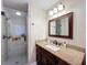 Updated bathroom featuring a glass shower and granite vanity with dark wood cabinets at 1025 E Georgia St, Bartow, FL 33830