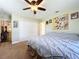 Spacious bedroom with a large bed, ceiling fan, and plenty of closet space at 1025 E Georgia St, Bartow, FL 33830