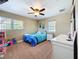 This bedroom features a comfortable bed, ceiling fan, and large windows for ample natural light at 1025 E Georgia St, Bartow, FL 33830