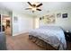 Spacious bedroom with a large bed, ceiling fan, and plenty of closet space at 1025 E Georgia St, Bartow, FL 33830