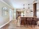 Kitchen bar with granite countertops, hardwood floors and stylish pendant lighting at 1025 E Georgia St, Bartow, FL 33830