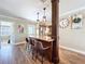 A modern kitchen bar area featuring a granite countertop, hardwood floors and decorative wall decor at 1025 E Georgia St, Bartow, FL 33830