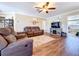 Cozy living room featuring a ceiling fan, hardwood floors and a large flat-screen TV at 1025 E Georgia St, Bartow, FL 33830