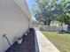 The home's side yard has a walkway leading to a white picket fence and green grass at 1025 E Georgia St, Bartow, FL 33830