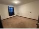 Spacious bedroom with carpeted floors and a window with blue curtains at 121 7Th Terrace Wahneta Way, Winter Haven, FL 33880