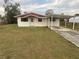 Front view of a single story house with carport at 121 7Th Terrace Wahneta Way, Winter Haven, FL 33880