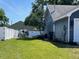 Spacious backyard featuring a white vinyl fence, lush lawn, and space for outdoor entertaining at 121 Belmont Dr, Winter Haven, FL 33884