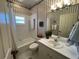 Traditional bathroom featuring a tub and shower, with a sink and vanity area at 121 Belmont Dr, Winter Haven, FL 33884