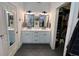 Bathroom featuring double sinks with white cabinets and sleek mirrors at 121 Belmont Dr, Winter Haven, FL 33884