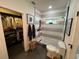 Modern bathroom with glass shower, tiled walls, black fixtures, and toilet with open-concept closet in view at 121 Belmont Dr, Winter Haven, FL 33884