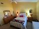 Bedroom featuring a wrought iron bed frame, hardwood furnishings, and vaulted ceiling at 121 Belmont Dr, Winter Haven, FL 33884