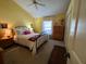 Bedroom featuring a wrought iron bed frame, hardwood furnishings, and lots of natural light at 121 Belmont Dr, Winter Haven, FL 33884