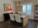 Open dining room features wood-look flooring, modern light fixture and shuttered window at 121 Belmont Dr, Winter Haven, FL 33884