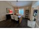 Open dining room features wood-look flooring, modern light fixture and shuttered window at 121 Belmont Dr, Winter Haven, FL 33884