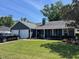 Well-maintained home with a two-car garage, dark blue siding, and lush green lawn at 121 Belmont Dr, Winter Haven, FL 33884