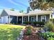 Charming single story home featuring an attached two-car garage, neat landscaping, and a welcoming covered front porch at 121 Belmont Dr, Winter Haven, FL 33884