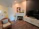 Inviting living room featuring modern dark accent wall, a decorative fireplace and mantel, and beautiful wood floors at 121 Belmont Dr, Winter Haven, FL 33884