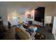 Bright living room showcasing dark accent wall, fireplace, dark wood floors, and an open floor plan leading to other areas at 121 Belmont Dr, Winter Haven, FL 33884