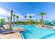 Large community pool with lounge chairs and umbrellas at 187 Brooke'S Pl, Haines City, FL 33844