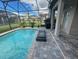 Relaxing screened pool and patio area, perfect for outdoor entertaining at 187 Brooke'S Pl, Haines City, FL 33844