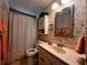 Bathroom featuring a neutral color scheme, vanity, toilet, and shower with curtain at 2055 S Floral Ave # 73, Bartow, FL 33830