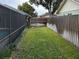 Long, narrow backyard with a wooden fence and pool at 2062 Katie Ct, Winter Haven, FL 33884