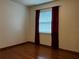 Bedroom with hardwood floors and window with burgundy curtains at 2062 Katie Ct, Winter Haven, FL 33884