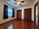 Bright bedroom featuring hardwood floors and double closets at 2062 Katie Ct, Winter Haven, FL 33884