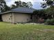 Tan house exterior with a manicured lawn and landscaping at 2062 Katie Ct, Winter Haven, FL 33884