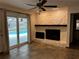 Living room with stone fireplace and sliding doors to the pool at 2062 Katie Ct, Winter Haven, FL 33884