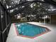 Inviting screened pool area with brick coping and spacious deck at 2062 Katie Ct, Winter Haven, FL 33884