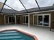 Inviting pool area with covered patio and sliding glass doors at 2062 Katie Ct, Winter Haven, FL 33884