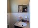 Bathroom with vanity sink, medicine cabinet, and tiled walls at 217 Bay E St, Davenport, FL 33837