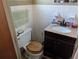 Clean bathroom with dark vanity and wood toilet seat at 217 Bay E St, Davenport, FL 33837