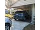 Carport with a dark-blue SUV parked inside at 217 Bay E St, Davenport, FL 33837